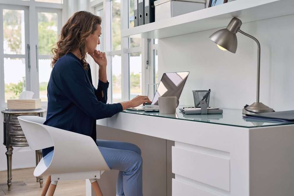 A woman using satellite Internet on her laptop.